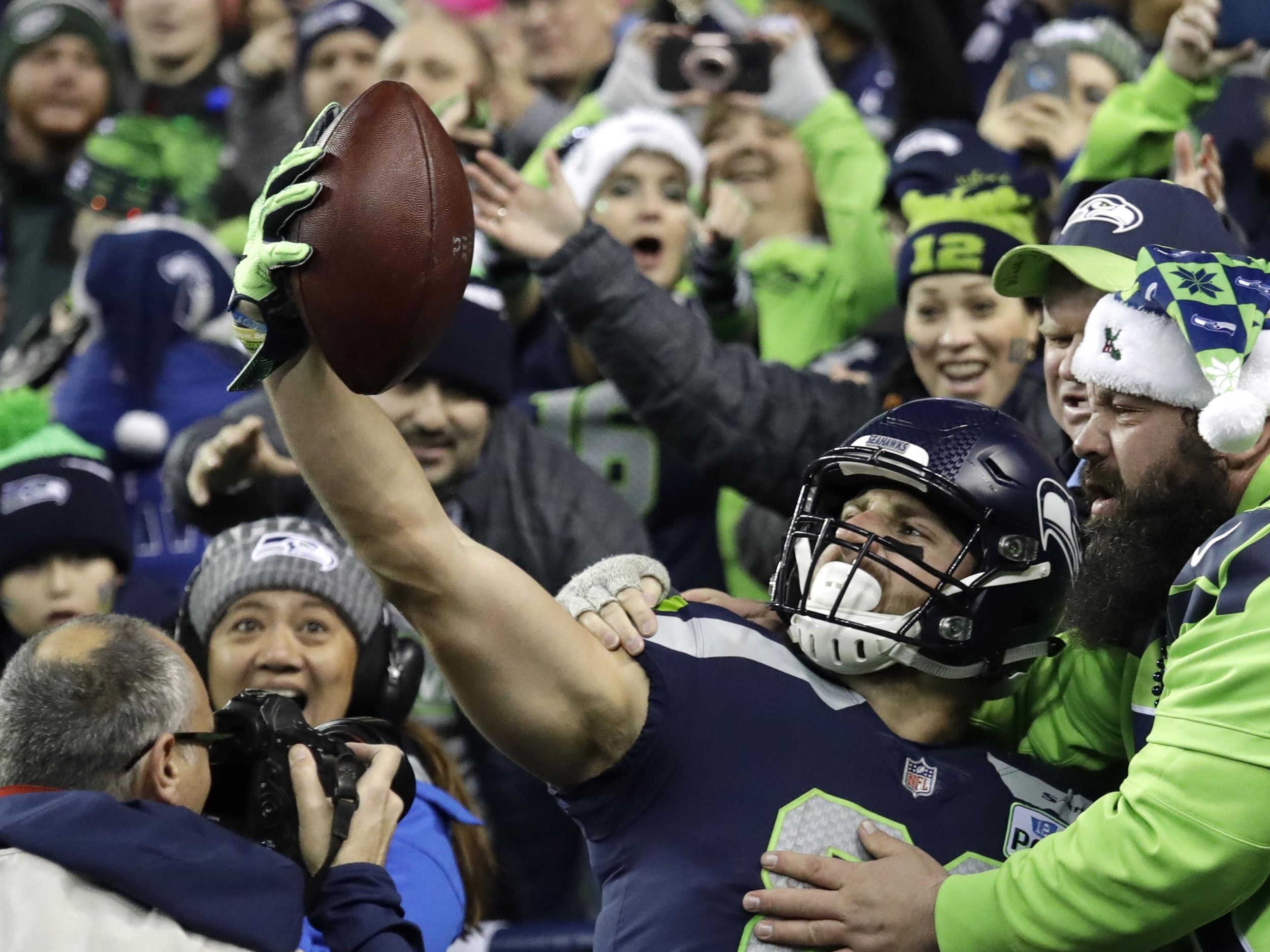 Seattle Seahawks tight end Nick Vannett (81) celebrates with a fan after he  scored a touchdown against the Kansas City Chiefs during the first half of  an NFL football game, Sunday, Dec.