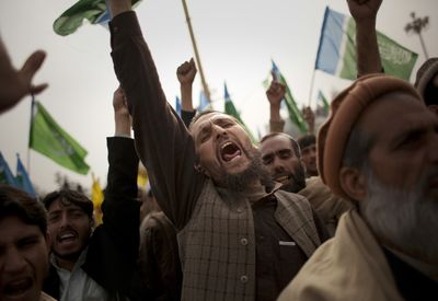 Pakistani tribesmen shout slogans against the military operations in tribal areas and drone attacks during a demonstration in Islamabad, Pakistan, on Friday.  (Associated Press / The Spokesman-Review)