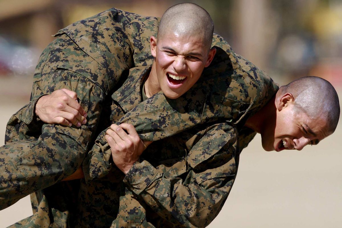 Marine Corps recruits carry each other during a fireman’s carry drill on the training grounds at Marine Corps Recruit Depot/San Diego on Oct. 11. The Marine Corps is working to make the 13-week boot camp as injury-free as possible.