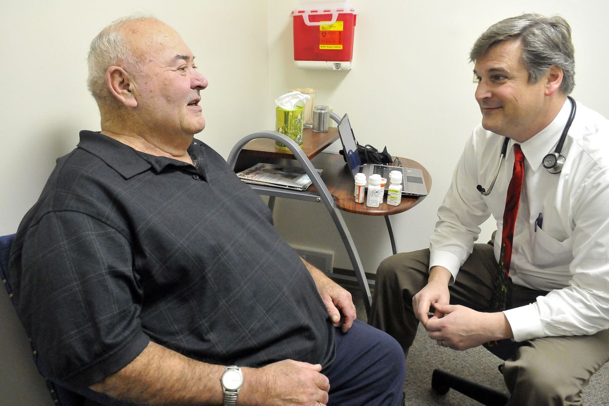 Patient Mike Haase, left, talks with Dr. Charles “Marty” Sackmann in an exam room at Sackmann’s clinic in downtown Ritzville. Sackmann and Dr. Valerie Eckley left the East Adams Rural Hospital and opened their own clinic in a downtown building after a disagreement over a contract with the hospital. (Jesse Tinsley)