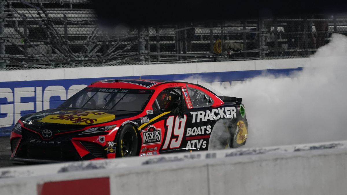 Martin Truex Jr. (19) does a burnout as he celebrates after winning a NASCAR Cup Series auto race at Martinsville Speedway in Martinsville, Va., Sunday, April 11, 2021.  (Associated Press)