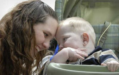 
Sarah Doyle, of Bellingham, Mass., poses with her 13-month-old son Aidan, after an appointment at Children's Hospital in Boston. Doyle has used Web sites to network and tell friends and family about developments since her son was born with his liver and intestines outside his body. Associated Press
 (Associated Press / The Spokesman-Review)