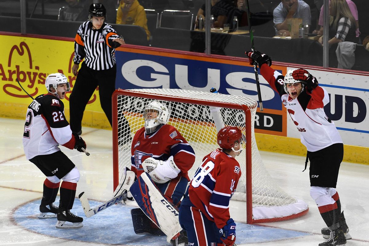 Prince George Prince George Cougars forward Craig Armstrong (22) and forward Jackson Leppard (8) celebrates teammate Cougars forward Connor Bowie (21) goal against Spokane Chiefs goalie Campbell Arnold (1) during the second period of a WHL hockey game, Fri., Oct. 11, 2019, in the Spokane Arena. (Colin Mulvany / The Spokesman-Review)