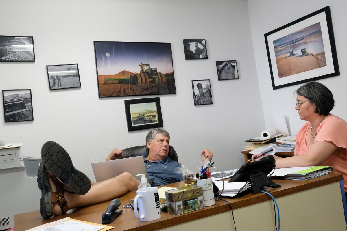 Rural attorney Rusty McGuire of McGuire, DeWulf, Kragt & Johnson goes over legal issues with Shani Hergert, St. John’s town clerk, on Thursday at his office in St. John, Wash.  (Tyler Tjomsland/The Spokesman-Review)