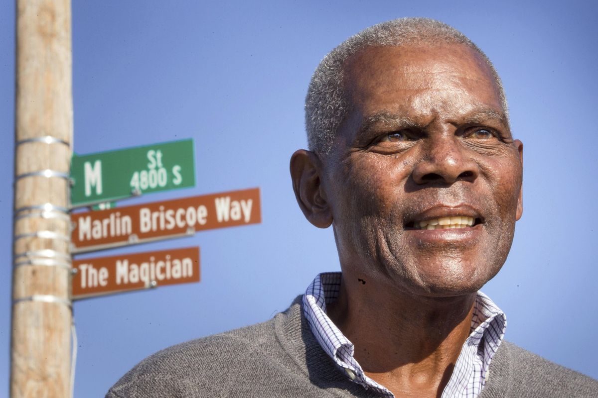 In this Oct. 22, 2014, file photo, Marlin Briscoe stands in front of a street that was renamed for him in Omaha, Neb. The Pro Football Hall of Fame calls the Omaha, Neb. native the first black quarterback in the modern era of pro football. He opened the door for many, including Carolina’s Cam Newton and Seattle’s Russell Wilson, who both pay homage to him. (Kent Sievers / Omaha World-Herald via AP)
