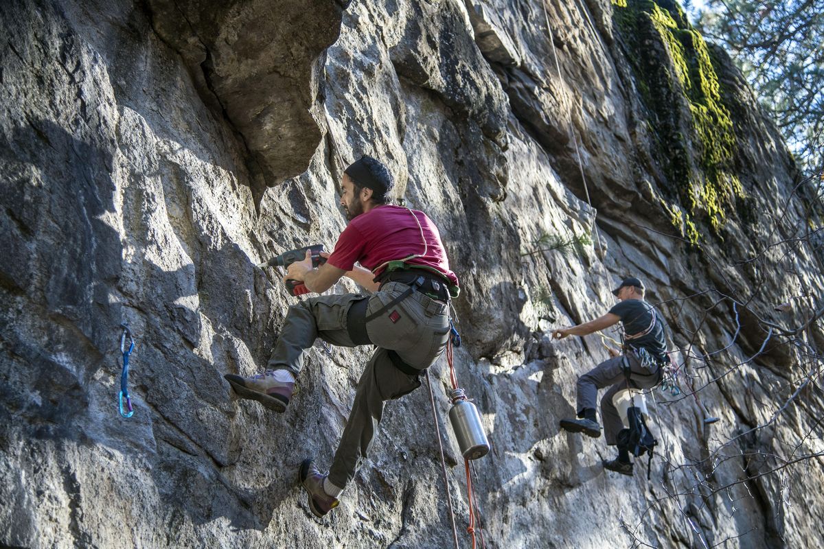 Arden Pete and Erik Lawson replace aging climbing bolts, Nov. 10, 2016, at the Dishman Hills climbing area in Spokane Valley, Wash. A group of rock climbers have started a non profit dedicated to maintaining the bolts.. The nonprofit is named after Andrew Bower, a local climber who died last year while fixing bolts in the Dishman climbing area. (Dan Pelle / The Spokesman-Review)