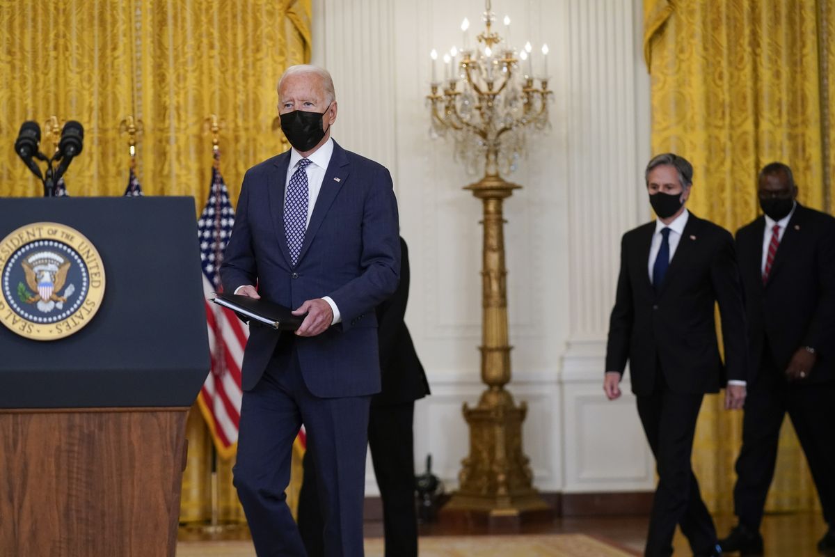 President Joe Biden arrives to speak about the evacuation of American citizens, their families, SIV applicants and vulnerable Afghans in the East Room of the White House, Friday, Aug. 20, 2021, in Washington. Secretary of Defense Lloyd Austin, right, and Secretary of State Antony Blinken, second from right, arrive with Biden.  (Manuel Balce Ceneta)