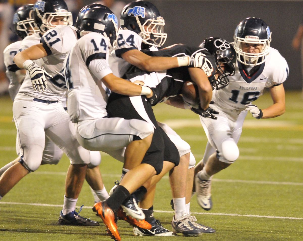 Gonzaga Prep defenders gang up to tackle Lewis and Clark receiver Connor Smith during first-quarter play Friday night. (Jesse Tinsley)