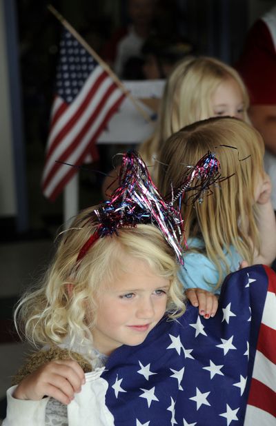 Joely Gardiner, 4, prepares  to lead the pre-Fourth of July parade for the Cottage Childcare and Learning Center on Thursday in Post Falls.  (Kathy Plonka)