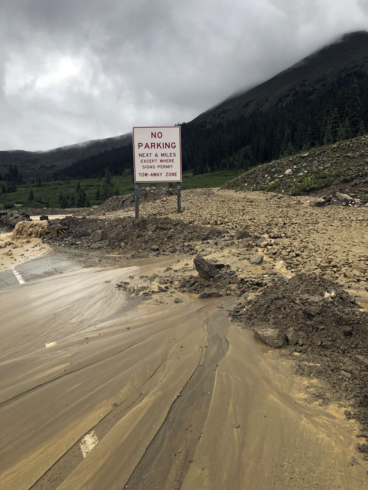 This image provided by the Colorado Department of Transportation shows mud and debris on U.S. Highway 6, Sunday, Aug. 1, 2021 west of Silver Plume, Colo. Mudslides closed some Colorado highways as forecasters warned of potential flash flooding on Sunday across the Rocky Mountain and Great Basin regions.  (HOGP)