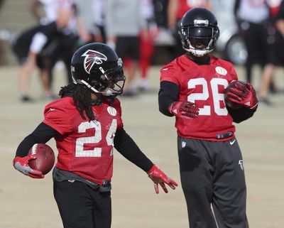 Atlanta Falcons running backs Devonta Freeman, left, and Tevin Coleman are close as brothers though the backfield duo may separate in the near future. (Curtis Compton / Associated Press)
