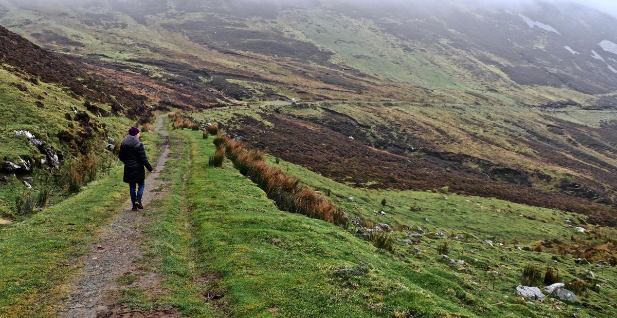 Writer John Carpenter’s wife, Mary Carpenter, walks along the Pilgrims Path near Teelin in County Donegal. The west coast of Ireland is best explored on foot. (John Carpenter / TNS)