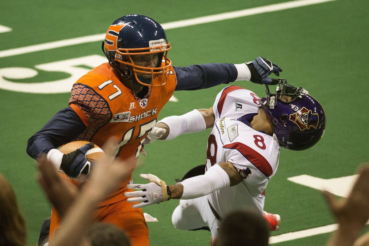 On his way to the end zone in the second quarter, Shock receiver Adron Tennell stiff-arms VooDoo defensive back Leslie Majors. (Colin Mulvany)