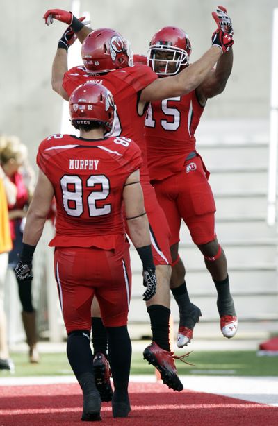 Utah running back John White (15) celebrates with tight end Westlee Tonga after scoring in the second quarter against Washington State.  (Associated Press)