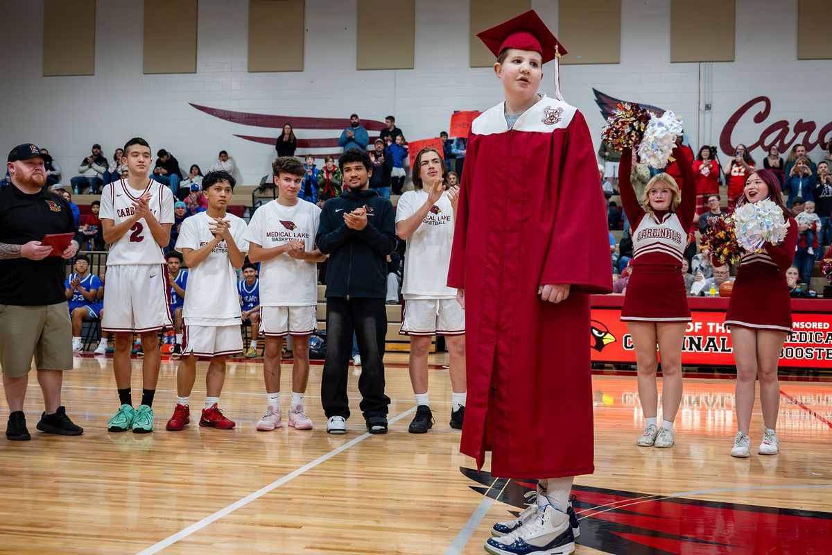 Owen Pitts listens to the crowd chant his name during a special basketball game and graduation ceremony in his honor Thursday night at Medical Lake High School. The doctors gave Pitts, who has brain cancer, three to six months to live in September, so his school stepped up to fulfill a couple of his last wishes: to graduate and to play in a basketball game.  (COLIN MULVANY/The Spokesman-Review)