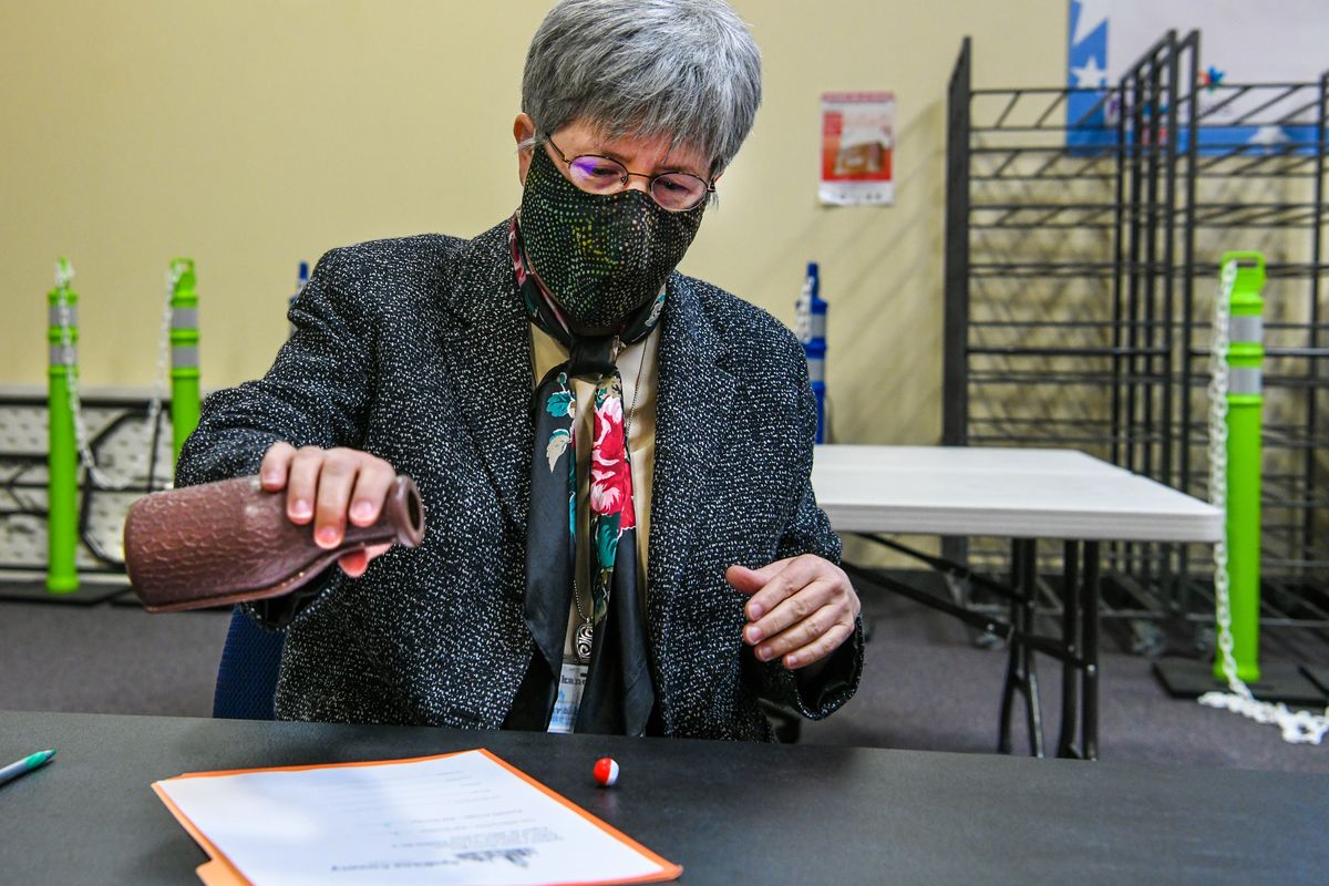 Spokane County Auditor Vicki Dalton conducts a tiebreaker for Rockford Council Position 3 race between Ivan Willmschen and Rachelle Arriaga by shaking out of a milk bottle one of two numbered balls, Thursday, Aug. 26, 2021. Number 2 came out of and declaired Willmschen the winner. He will advance to the general election against Mark Lonam Jr.  (DAN PELLE/THE SPOKESMAN-REVIEW)