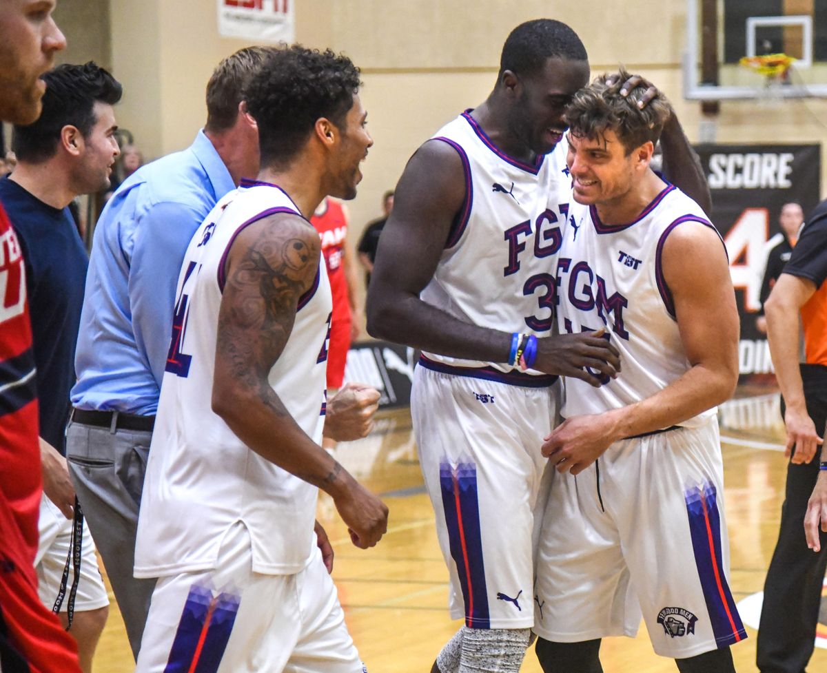 Few Good Men guard Matt Bouldin is hugged by teammate Sam Dower after Bouldin hit a pair of free throws to beat Team Utah in The Basketball Tournament, Friday, June 29, 2018 at Lewis and Clark High School. (Dan Pelle / The Spokesman-Review)