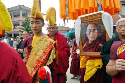 
Tibetan Buddhist monks carry a portrait of their spiritual leader the Dalai Lama during celebrations to mark his 70th birthday in Katmandu, Nepal 
 (Associated Press / The Spokesman-Review)