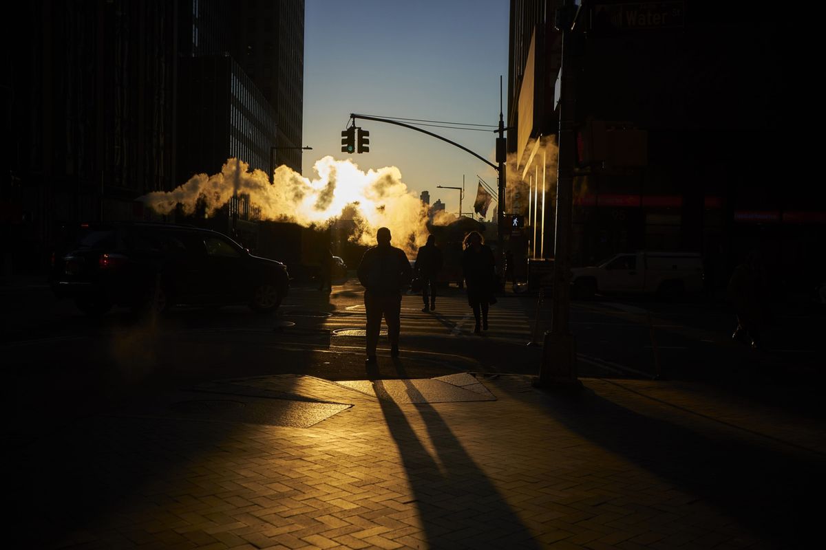 Steam rises as pedestrians cross a street near the New York Stock Exchange in December 2018. Technology stocks were battered Thursday.  (John Taggart/Bloomberg)