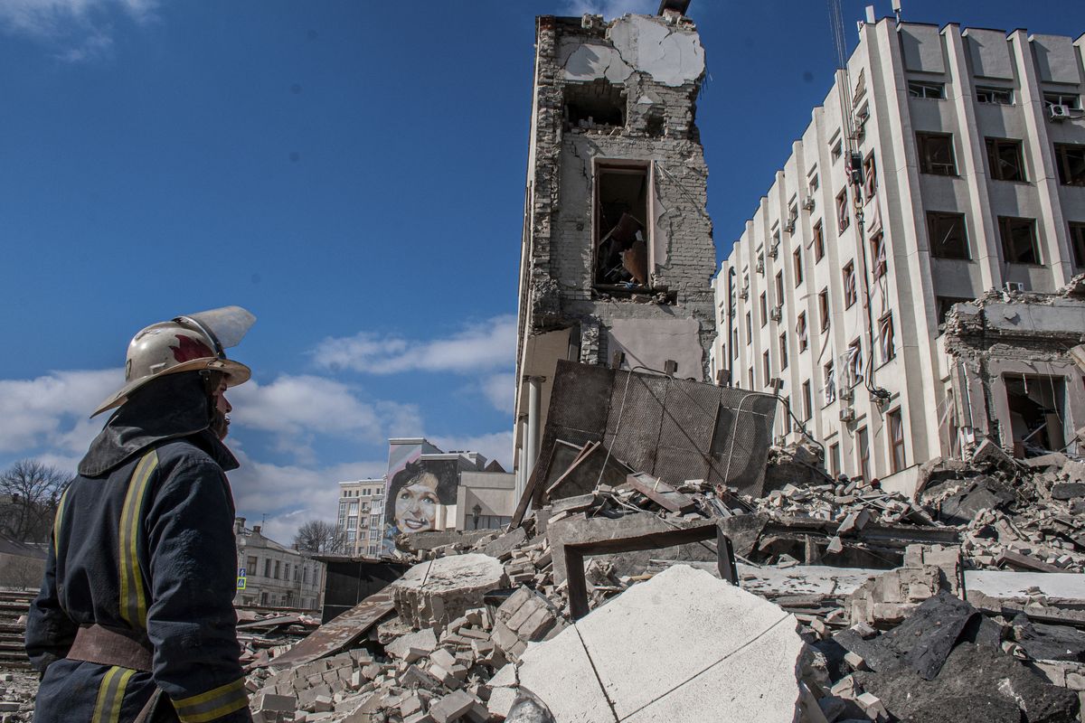 FILE - Rescuers work at the site of the National Academy of State Administration building damaged by shelling in Kharkiv, Ukraine, March 18, 2022. (Andrew Marienko)