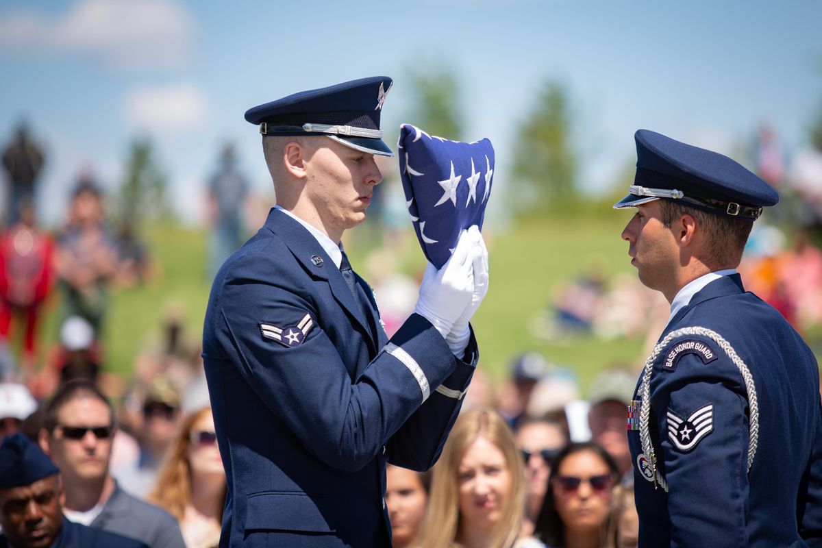 Fairchild Air Force Base Honor Guard members conduct a flag folding ceremony during a Memorial Day Remembrance at the State Veterans Cemetery in Medical Lake, Wash. on May 27, 2019. The flag was then presented to Dee Belzer, the sister of fallen service man Luke Conley, after Taps was played with a three volley salute. (Libby Kamrowski / The Spokesman-Review)