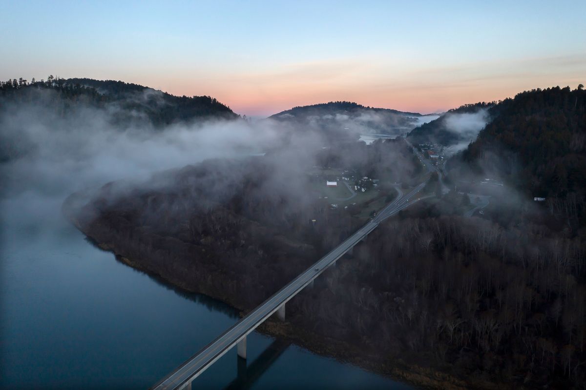 In this aerial image taken from a drone, the city of Klamath, Calif., home of the tribal headquarters for the Yurok Tribe, dots the side of U.S. Highway 101 at sunrise on Jan. 21, 2022. The Native American tribe has issued an emergency declaration on human trafficking and missing women. There have been five instances in the past 18 months where Indigenous women have gone missing or been murdered between San Francisco and the Oregon border. (Nathan Howard)