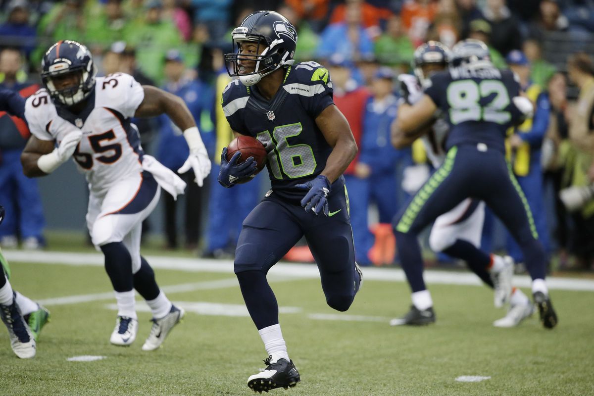 Seahawks rookie Tyler Lockett returns a kickoff 103 yards for a touchdown against the Broncos in the first half Friday night. (Associated Press)