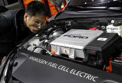 
Hyundai Motor Company's Sang-Hee Lee views the hydrogen fuel cell electric power plant in the Ford Focus during media previews at the North American International Auto Show in Detroit on Monday.
 (Associated Press / The Spokesman-Review)