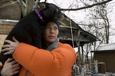 
Linda Bergeson visits her house at 1630 W. Riverside Ave. on Thursday afternoon after it had been gutted by fire the night before. Bergeson awoke around 11:50 p.m. Wednesday and realized there was a blanket of smoke above her head. She grabbed her animals, including her dog, Radar,  before running to her next-door neighbor's house. 
 (Kathryn Stevens / The Spokesman-Review)
