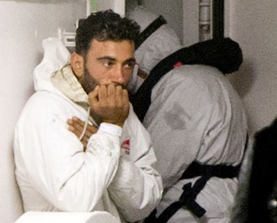 Tunisian navigator Mohammed Ali Malek waits to disembark Monday at Catania Harbor, Italy. (Associated Press)
