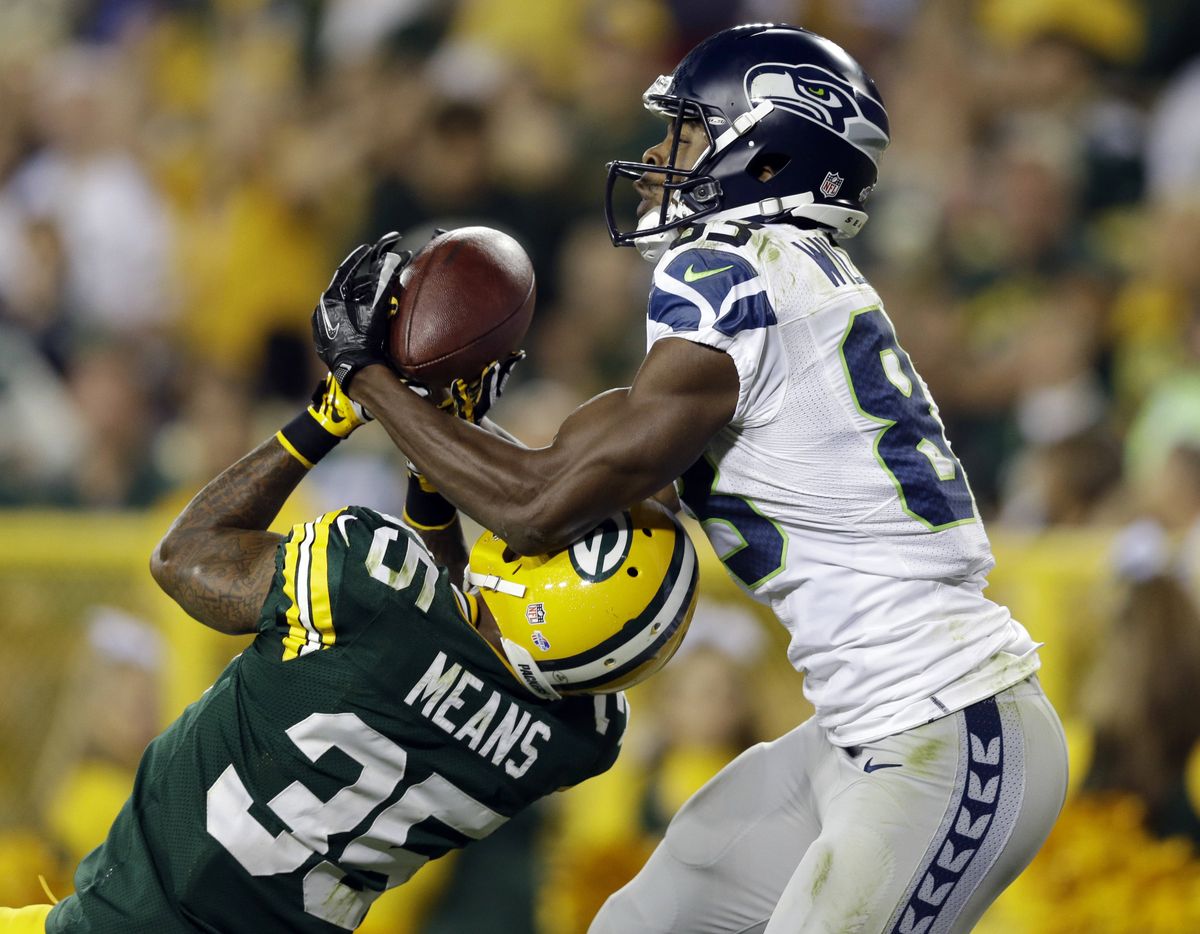 Stephen Williams of the Seahawks catches a touchdown pass, snagging the ball away from the Packers’ Loyce Means in the second half. (Associated Press)