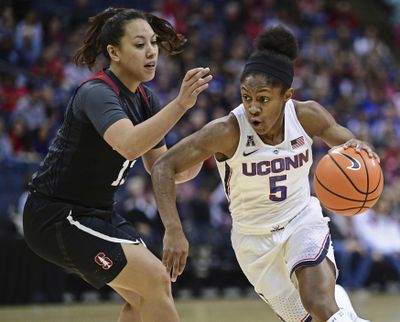 Connecticut’s Crystal Dangerfield drives on Stanford’s Marta Sniezek during the Huskies’ victory on Sunday. (David Dermer / AP)