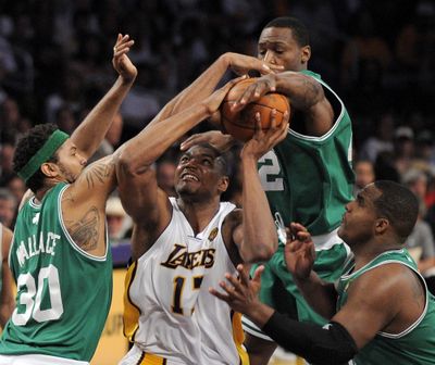 Celtics Rasheed Wallace, left, Tony Allen, top, and Glen Davis swarm Lakers center Andrew Bynum in first half. (Associated Press)