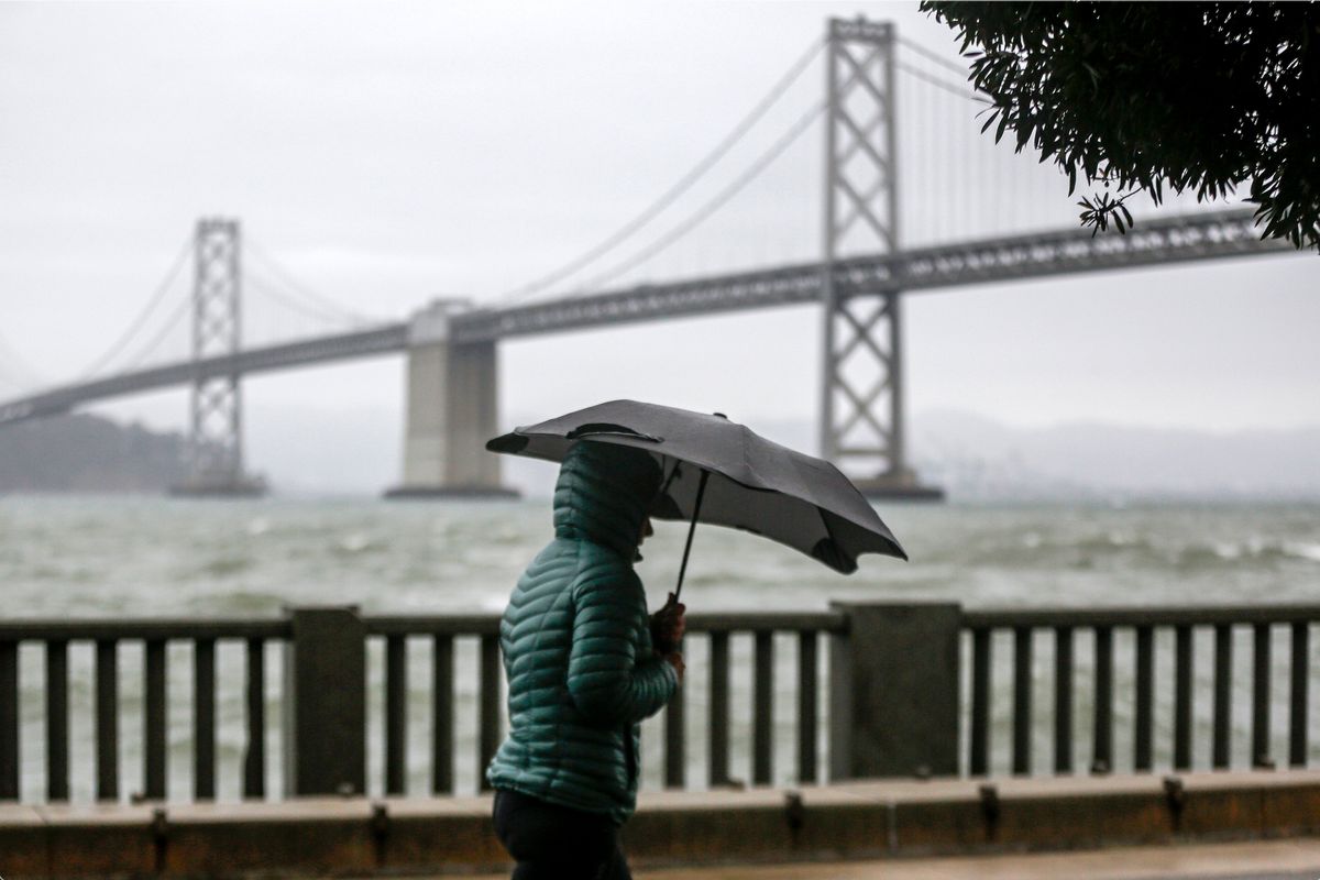 A cold weather front brings clouds skies and rainstorms to downtown San Francisco, Calif., on Sunday, Dec. 12, 2021. Meteorologists say the storms are just the beginning of an "atmospheric river" that will bring more intense rainfall and heavy snow in the Sierras. A significant storm ramped up Sunday with snow in Northern California that forced drivers to wrap their tires in chains and light rain in the lower elevations. The storm promises to drop up to 8 feet of snow on the highest peaks and drench other parts of the state. (Brontë Wittpenn)