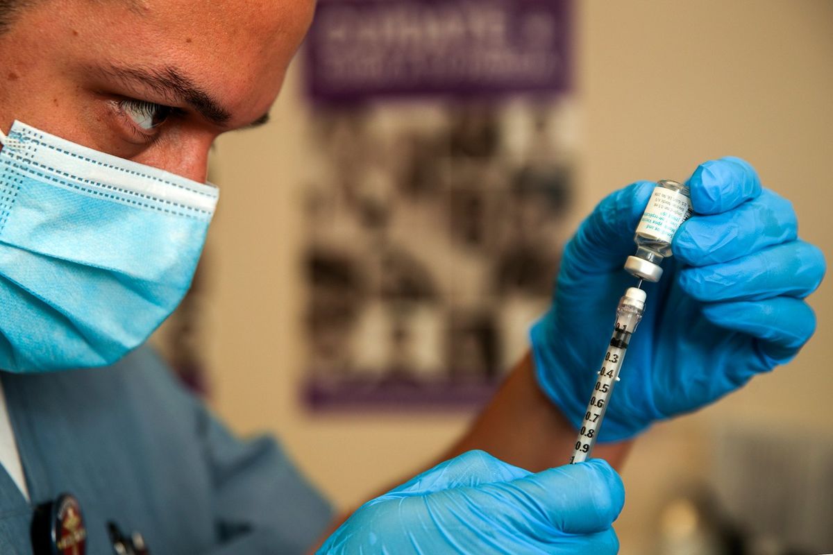 Luis Garcia, a registered nurse, prepares an mpox vaccine in August 2022 at St. John’s Well Child & Family Center in Los Angeles.  (Irfan Khan)