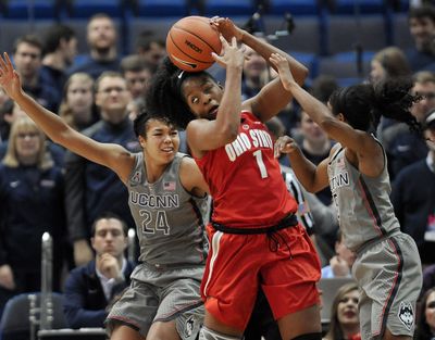 Ohio State's Stephanie Mavunga, center, looses control of the ball under pressure from Connecticut's Napheesa Collier, left, and Crystal Dangerfield, right, in the second half of an NCAA college basketball game, Monday, Dec. 19, 2016, in Hartford, Conn. (Jessica Hill / Associated Press)
