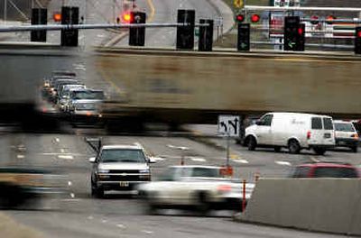 
Southbound cars on Pines wait for a train to pass at the intersection of Pines and Indiana on  Thursday in Spokane Valley. 
 (Liz Kishimoto / The Spokesman-Review)