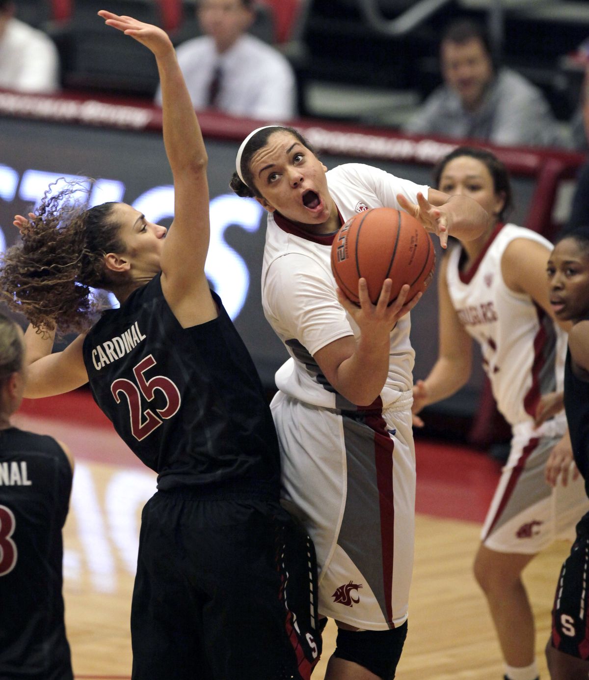 WSU’s Mariah Cooks tries to score around Stanford’s Erica Payne on Saturday in Pullman. (Associated Press)