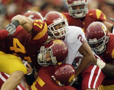 
Washington State's Charles Dillon, center, and the rest of the Cougars were brought down hard by USC. 
 (Associated Press / The Spokesman-Review)
