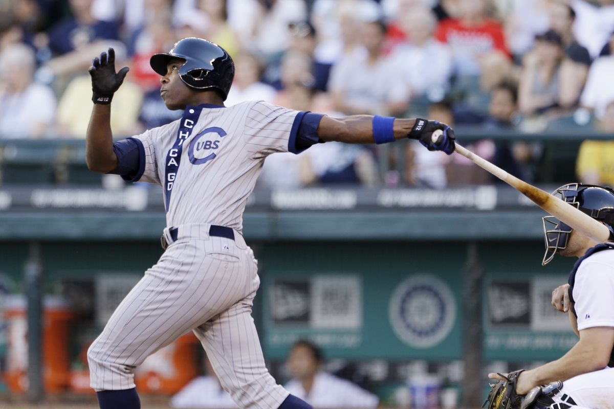 Cubs’ Alfonso Soriano hits a two-run homer against the Mariners in the 11th inning. (Associated Press)