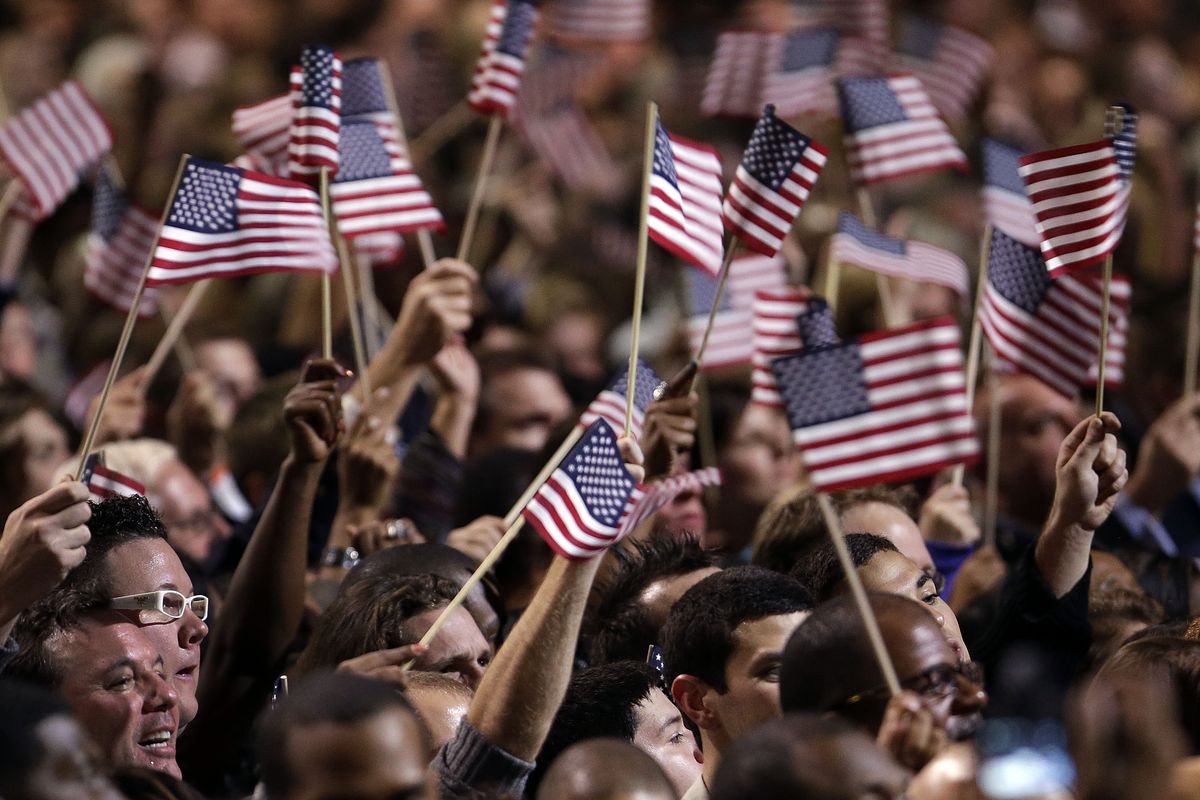 Supporters wave flags during President Barack Obama