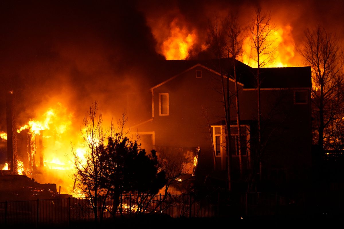 Homes burn as wildfires rip through a development Thursday, Dec. 30, 2021, in Superior, Colo.  (David Zalubowski)