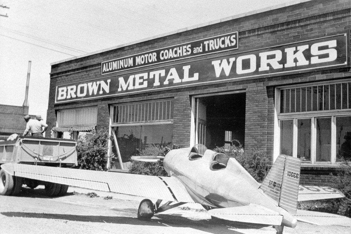 Circa 1935 - Outside Brown Metal Works at Grant Street and East Sprague Avenue, sits one of the all-aluminum airplane designed by Thoburn C. Brown and built by Thoburn and his older brother William R. Brown in the early 1930s. “We were tinsmiths,” said Thoburn Brown in 1972. “Its the only way we knew how to build.” The first plane was destroyed in a fire and this one, and possibly another, were sold off. The aircraft company never took off but the business built truck trailers, ore cars and bus coaches for many years. (Northwest Room/Spokane Public Library / SR)