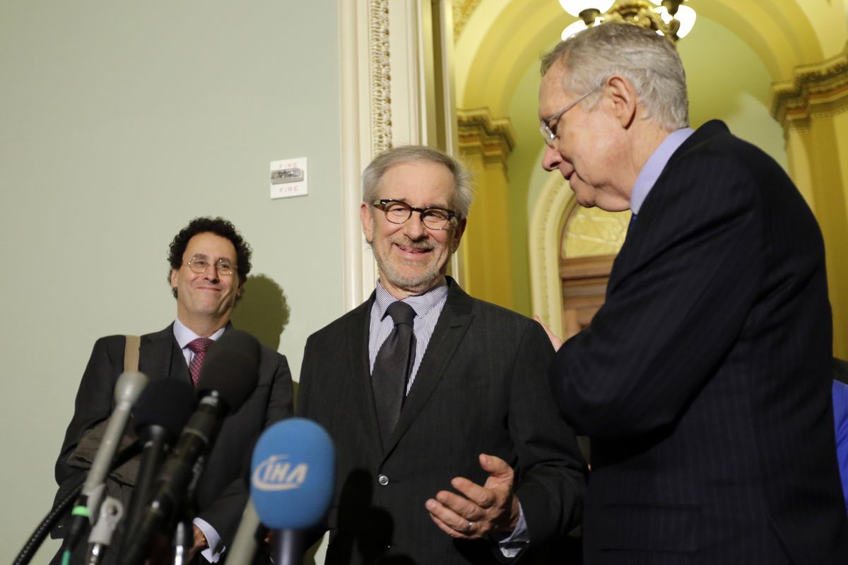 Writer Tony Kushner, left, director Steven Spielberg, and Senate Majority Leader Harry Reid of Nevada, pause during a media availability before a screening of the movie "Lincoln," for members of Congress, on Capitol Hill, Wednesday, Dec. 19, 2012 in Washington. (Alex Brandon / Associated Press)