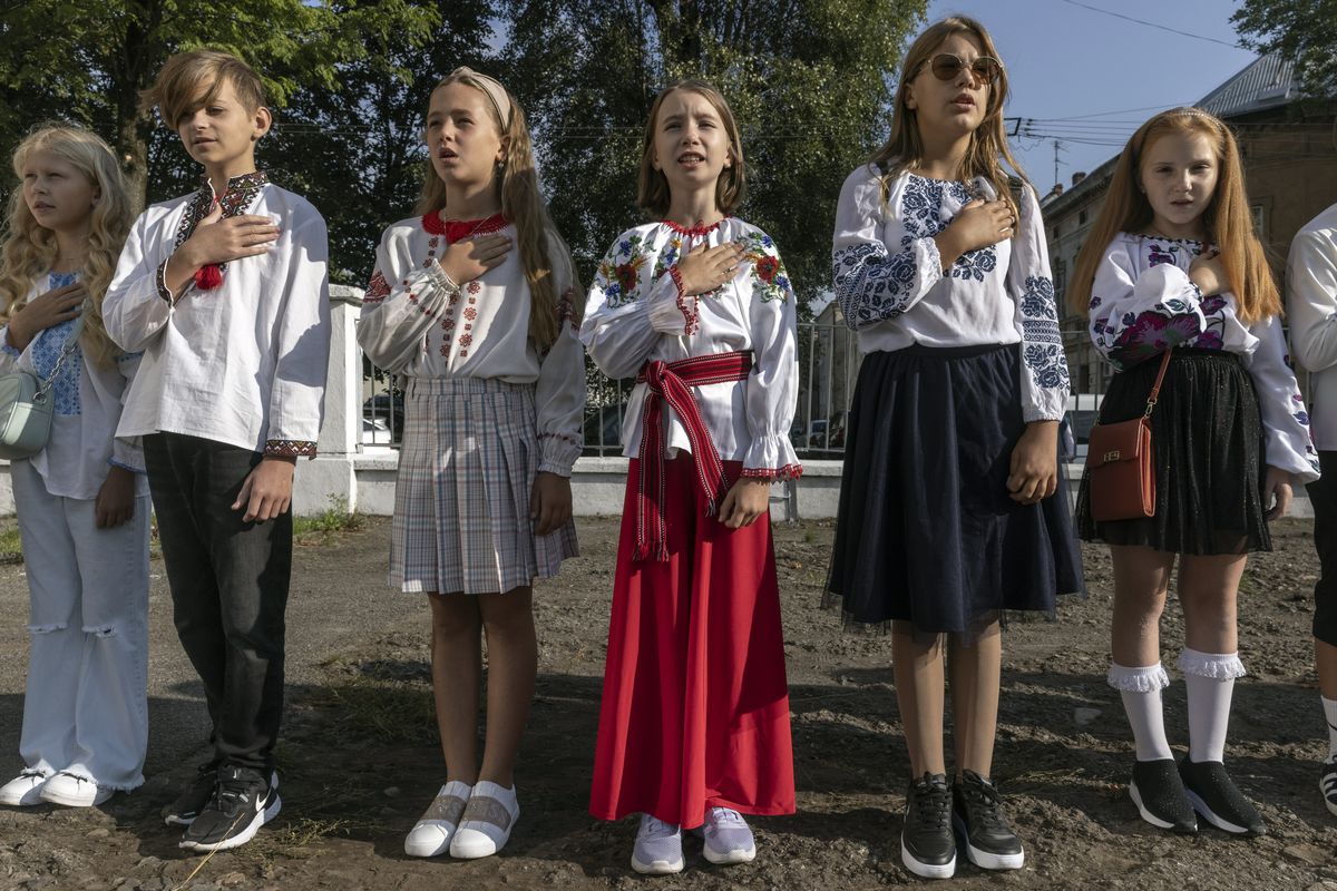 Students sing the Ukrainian national anthem on a school playground in Lviv on Friday, Sept. 1, 2023, the first day of the school year. For Ukraine