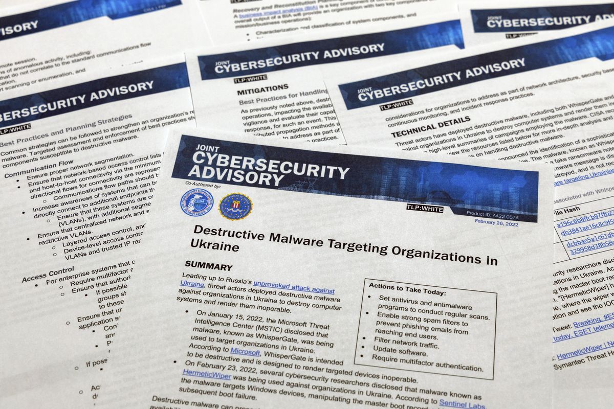 A Joint Cybersecurity Advisory published by the Cybersecurity & Infrastructure Security Agency about destructive malware that is targeting organizations in Ukraine is photographed Monday, Feb. 28, 2022.  (Jon Elswick)