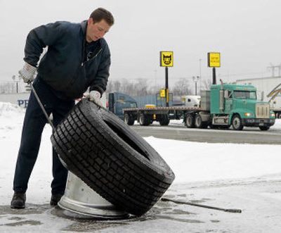 Shawn Olszewski dismounts the new Michelin X-One truck tire at a tire shop in Brecksville, Ohio.
(Associated Press / The Spokesman-Review)