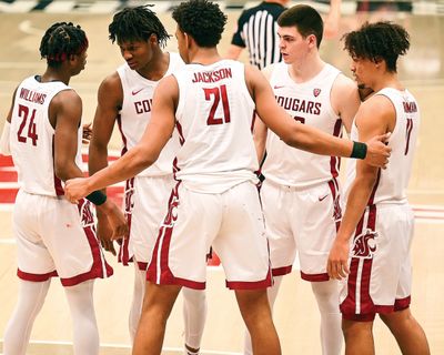 Washington State guard Noah Williams, left, forward Efe Abogidi, left-center, center Dishon Jackson, center, forward Andrej Jakimovski, right-center, and forward DJ Rodman huddle up after a timeout in the second overtime of a Pac-12 game against Stanford on Feb. 20 in Pullman. (Associated Press)
