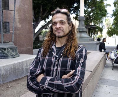 Matthew Lentz, who says he was fathered by convicted murderer Charles Manson at an orgy, stands outside Los Angeles Superior Court Tuesday, May 8, 2018. He carried letters he said Manson sent him from prison and hoped to show them to a judge at a hearing over claims on Manson's estate. But he arrived too late for the hearing, and has until July 13 to show cause why he shouldn't be dismissed from the case. (Brian Melley / Associated Press)