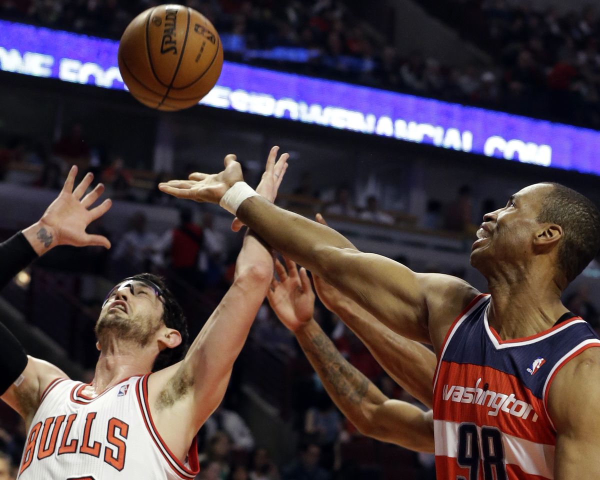 Washington Wizards center Jason Collins, right, battles for a rebound against Chicago Bulls guard Kirk Hinrich. (Associated Press)